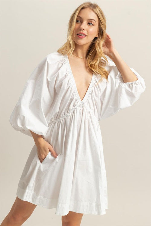 White poplin dress with ruched details and side pockets