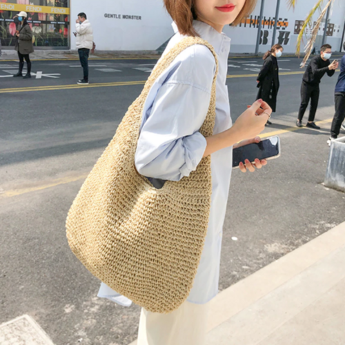 Bohemian-style straw shoulder bag on sandy beach