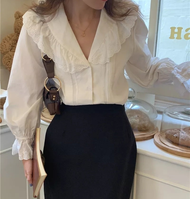 Woman wearing vintage-style embroidered cotton blouse with pagoda sleeves