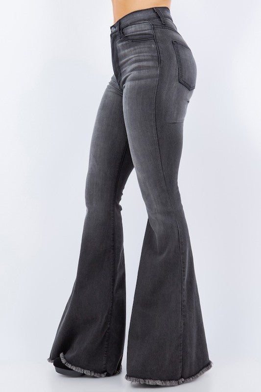 Model showcasing side view of burgundy flared jeans