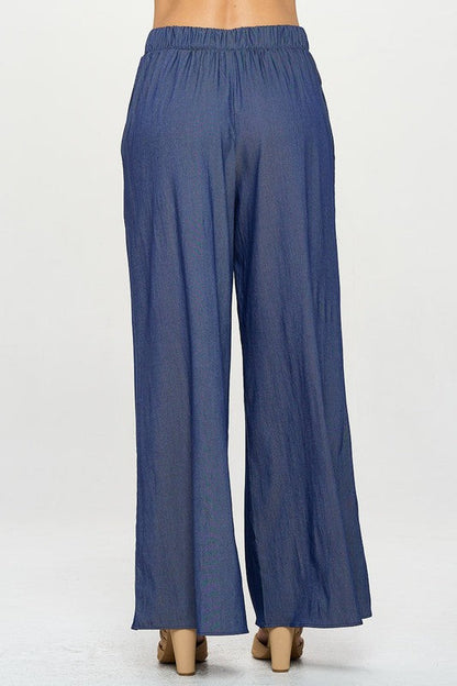 Model walking in wide leg Tencel pants with flowy silhouette
