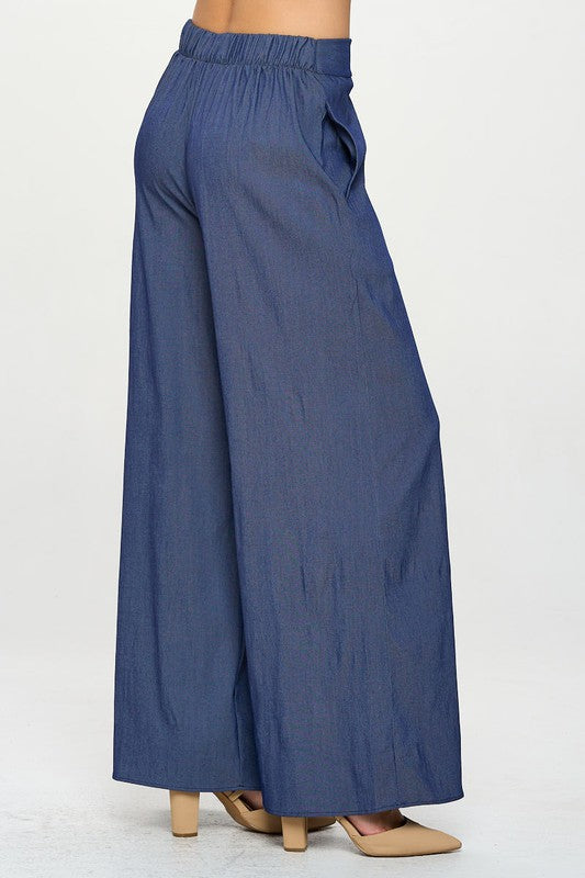 Side profile of model in oversized straight leg Tencel trousers