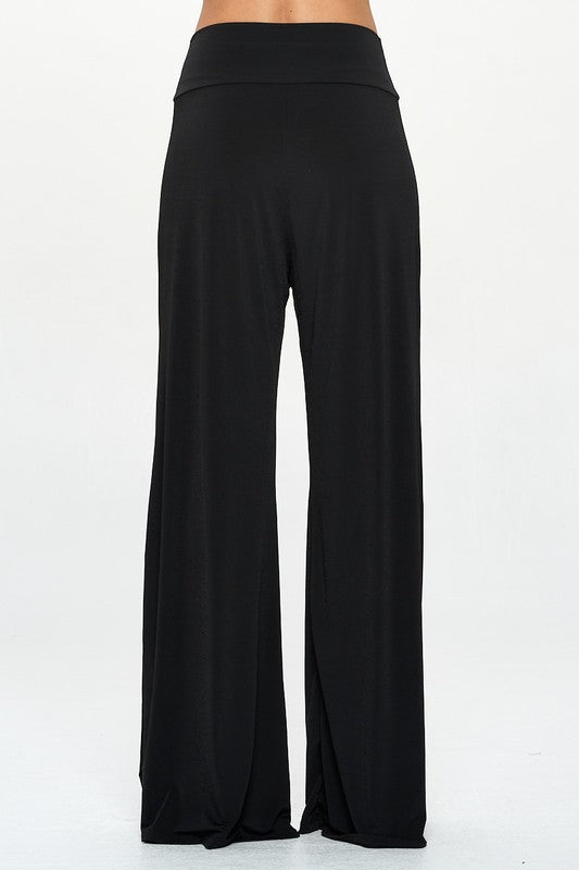 Back view of model wearing black wide leg pants with thick waistband