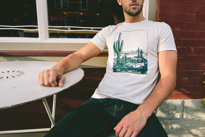 Model wearing soft oatmeal t-shirt with vintage off-road design