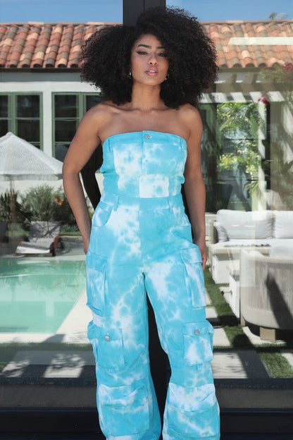 Woman wearing sky blue tie-dye strapless jumpsuit outdoors