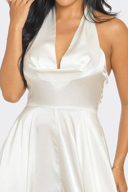 Ivory Serenity Jumpsuit styled with statement earrings and clutch