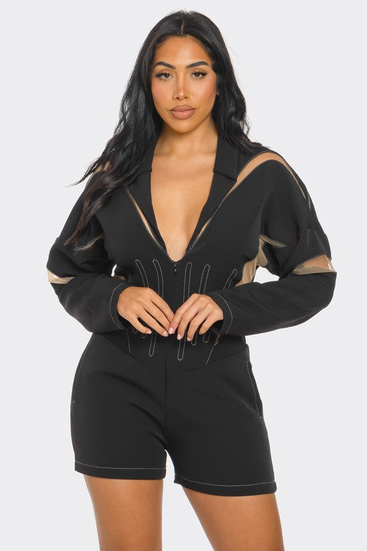 Woman wearing chic mesh-panelled black romper with plunging neckline