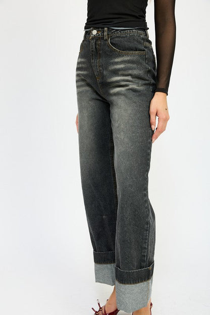 Woman modeling washed denim pants with fold over waistband