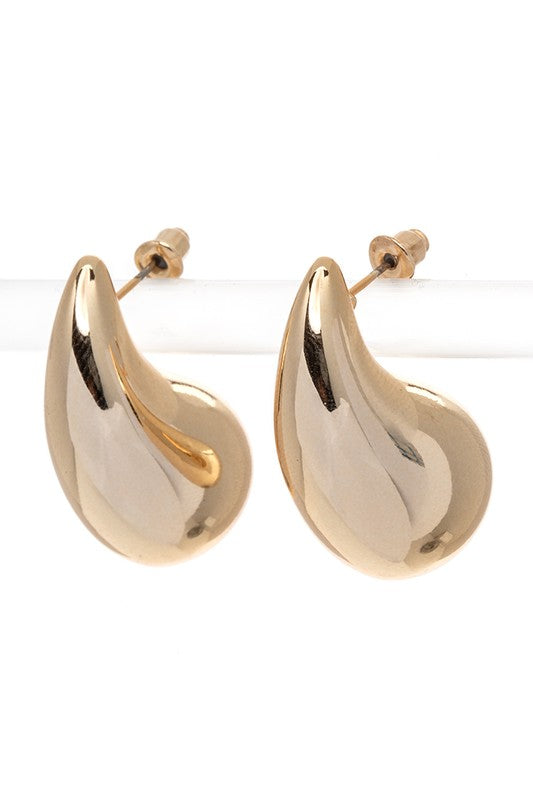 Elegant gold-tone droplet earrings displayed on jewelry stand