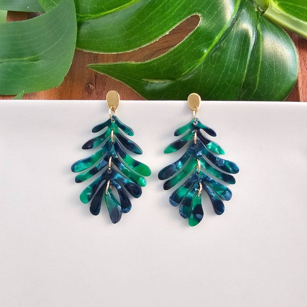 Lightweight acetate palm earrings on white background