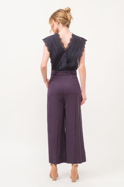 Back view of jumpsuit showing adjustable tie waist and relaxed fit