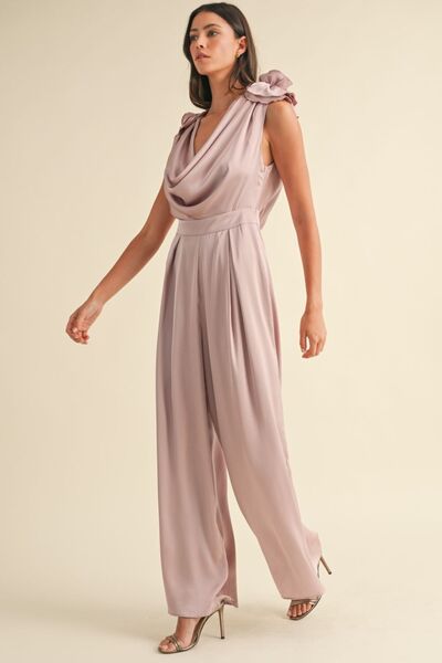Satin jumpsuit with dramatic deep cowl neckline and floral embellishments