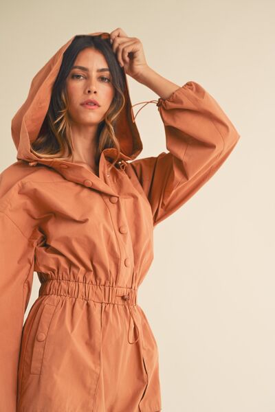 Cozy hooded romper with ruched waist and snap button front