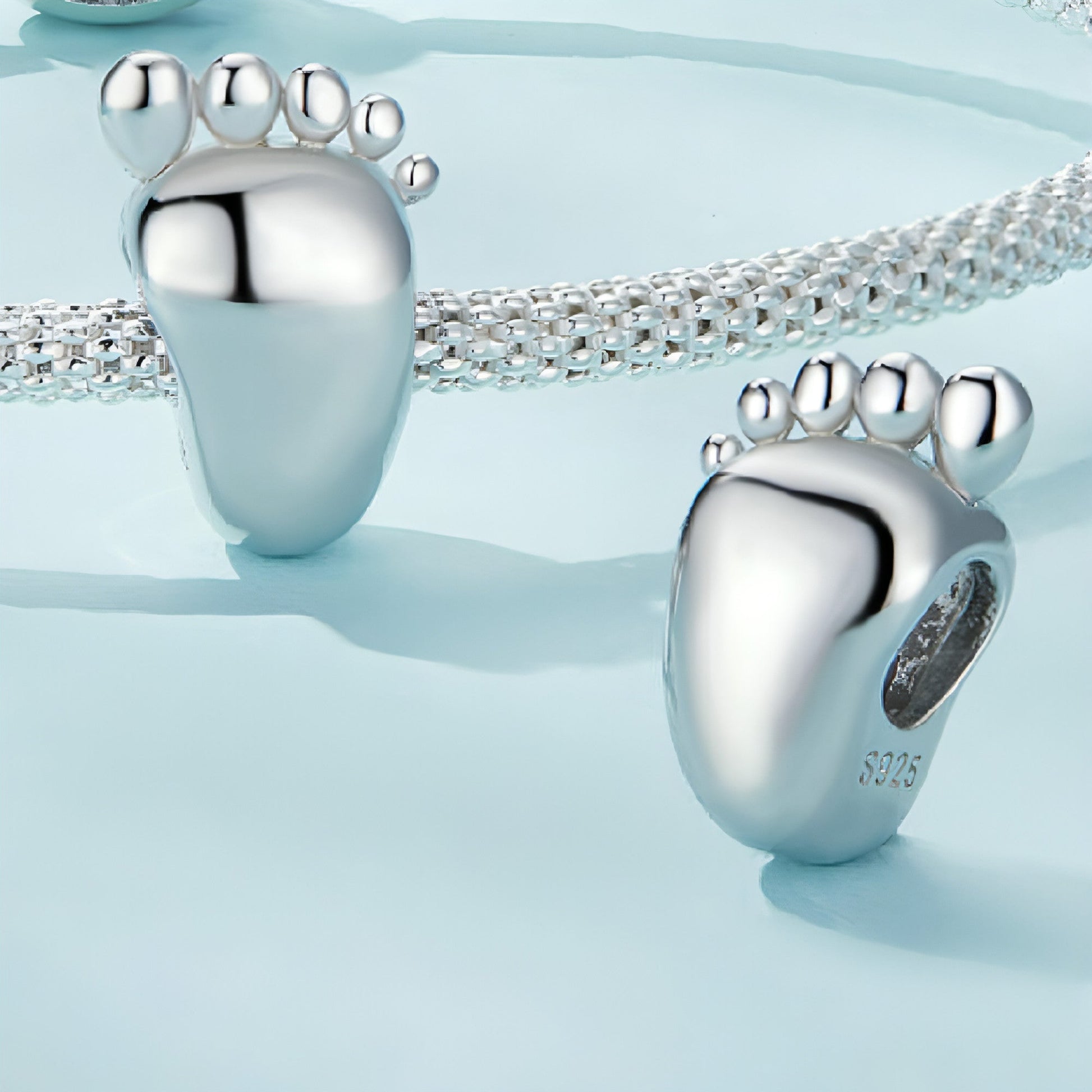 14mm silver charm with engraved baby feet on bracelet