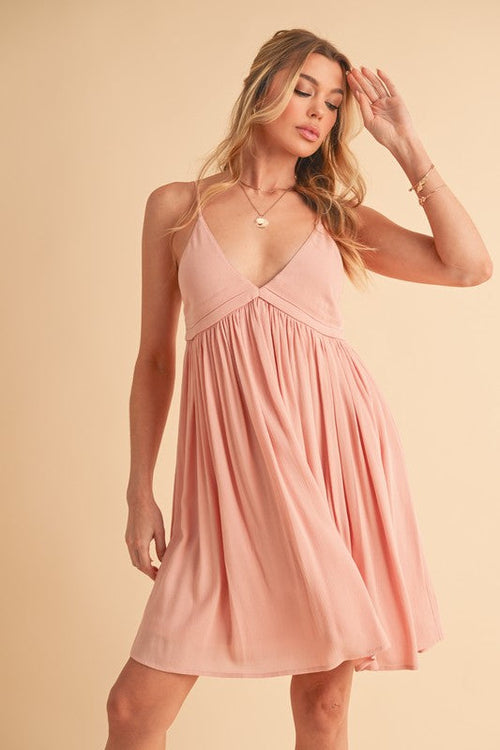 Elegant plunge cami dress in rayon displayed on hanger
