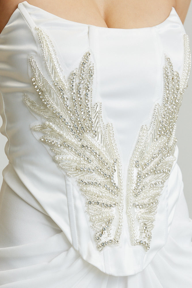 strapless satin gown with pointed bustline, rhinestone pearl angel wing applique