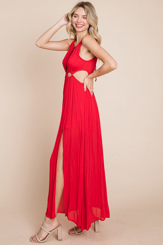 Side view of model in flowy halter maxi dress with high slit