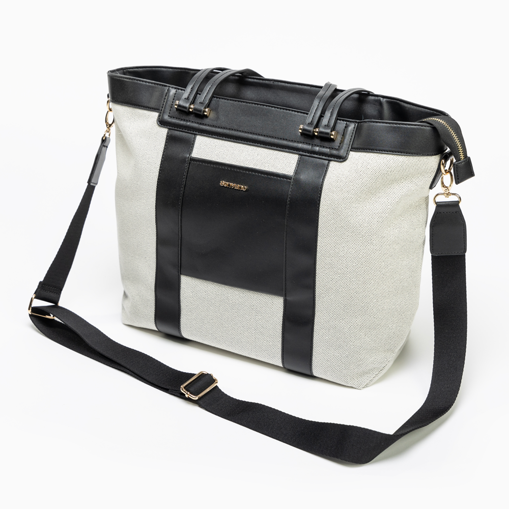 Stylish diaper tote worn crossbody with baby essentials
