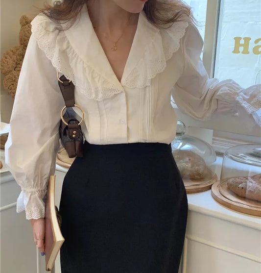 Woman wearing vintage-style embroidered cotton blouse with pagoda sleeves