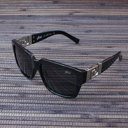 Stylish silver sunglasses resting on marble with South Beach vibe