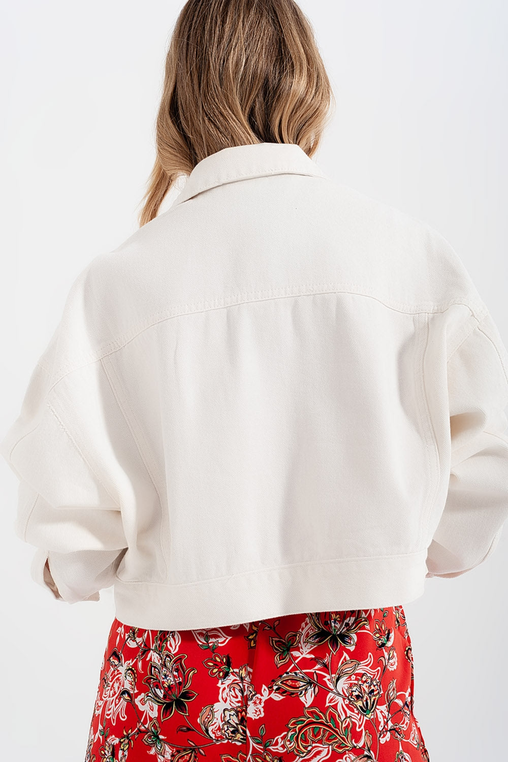 Back view of diamante embellished white denim jacket – festival-ready style