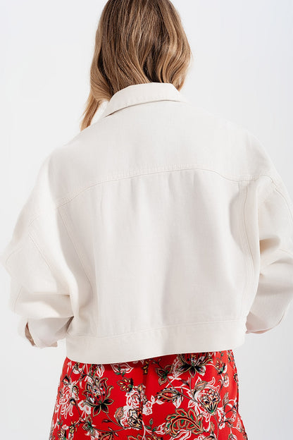 Back view of diamante embellished white denim jacket – festival-ready style