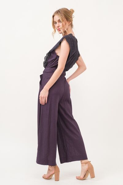 Stylish jumpsuit with laced neckline and practical side pockets
