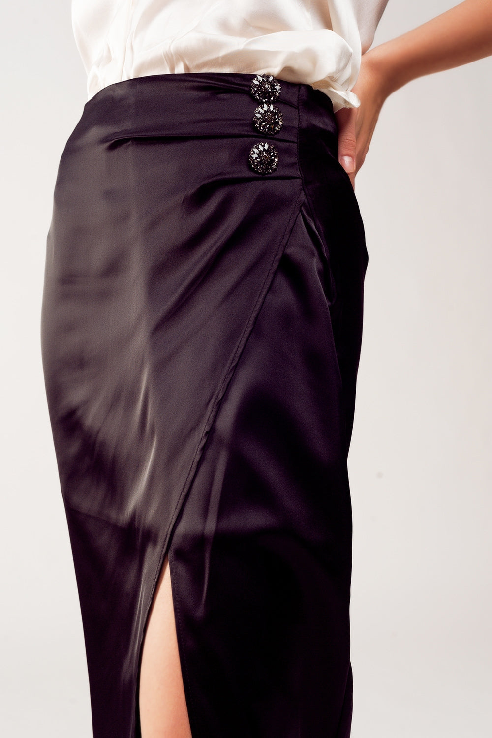 Embellished detail on black satin party skirt – flattering bodycon style